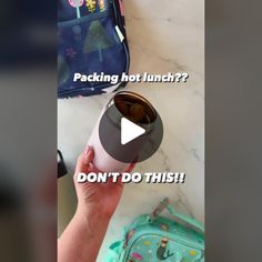 a person holding a cup with the caption packing hot lunch? don't do this