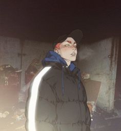 a man in a black jacket and hat standing next to a pile of trash at night