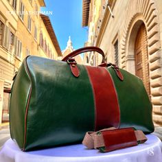 This Italian leather travel bag is expertly handcrafted in Florence, Italy, using the finest genuine leather. Designed for men seeking premium quality, luxury, and modern Italian fashion. Elevate your style with this exquisite accessory. . Size: Height: 30 cm (11.81 inches) Depth: 55 cm (21.65 inches) Width: 25 cm (9.84 inches) . The story of this travel bag: In the heart of Italy, where the rich legacy of craftsmanship thrives, there existed a renowned workshop dedicated to creating exquisite travel accessories. Among their coveted collection were the handmade duffle bags, carefully crafted to cater to the needs of discerning travelers seeking both style and functionality. These duffle bags, designed specifically as men's travel gear, embodied the essence of Italian travel bags. The artis Luxury Rectangular Travel Bag With Smooth Grain, High-end Leather Travel Bag For Everyday Use, High-end Leather Rectangular Travel Bag, Luxury Green Bag With Smooth Grain, High-end Leather Travel Bag, High-end Rectangular Leather Travel Bag, Green Leather Travel Bag With Luggage Sleeve, Green Leather Duffle Bag With Luggage Sleeve, Green Leather Travel Bag For Daily Use