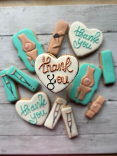 decorated cookies in the shape of doctors and nurse's instruments with thank you written on them