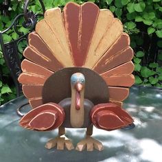 a wooden turkey sitting on top of a table