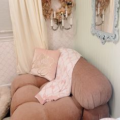 a living room filled with furniture next to a wall mounted chandelier and mirror