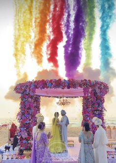 a group of people that are standing in front of a table with flowers on it