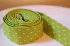 a green and white polka dot ribbon on a plate