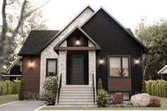 a house that has some lights on in front of the door and steps leading to it