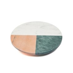 a marble plate with two different colors on the top, and one is white and green