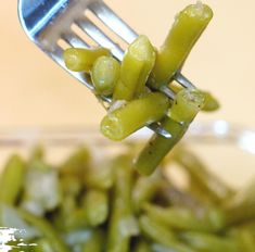 a fork with some green beans on it