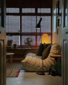 a living room filled with furniture and windows