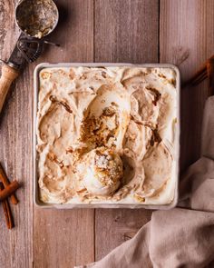 an ice cream dish with cinnamon sticks on the side