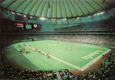 a stadium filled with lots of people watching a football game