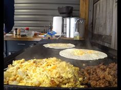 some food is cooking on an outdoor grill