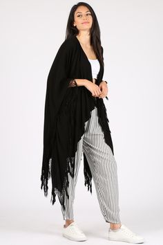 A light take on the poncho, this versatile piece can also act as a shawl and beach coverup. Please note this style is unisex. Fabric Content: 60% Cotton, 40% Rayon, made in Morocco. Sizing: O/S Black Beach Poncho One Size, Black One Size Poncho For Beach, Black One Size Beach Poncho, Summer Bohemian Black Shawl, Casual Beach Shawl For Spring, Bohemian Black Shawl For Summer, Casual Summer Shawl For Beach, Casual Beach Shawl For Summer, Chic Beach Cover-up Poncho