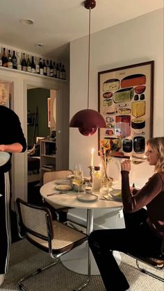 two women sitting at a table in a kitchen