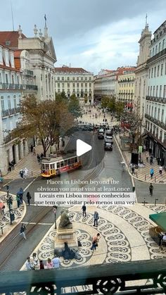 an aerial view of a street with people walking and sitting on the benches in front of it