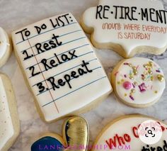 decorated cookies with writing on them sitting on a table