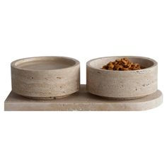 two concrete bowls with food in them