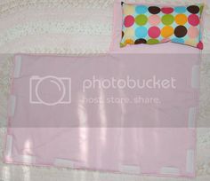 a pink mat with polka dots on it and a pillow in the middle that says photobuckett