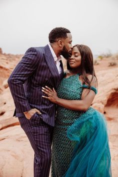 a man in a suit and woman in a blue dress standing next to each other