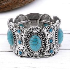 Introducing the stunning Turquoise Bohemian Bracelet - the perfect way to add character to your bohemian wardrobe. This beautiful accessory, handmade from exquisite imitation turquoise beads and zinc-alloy, boasts intricate detailing that catches the eye, while carrying with it positive symbolism of power, wisdom, and luck. It's an excellent gift, especially for special December-born friends and family. With its adjustable elasticity settings, you can easily slip it on or off, making it a comfor Adjustable Turquoise Metal Cuff Bracelet, Adjustable Turquoise Vintage Bangle, Bohemian Turquoise Metal Cuff Bracelet, Turquoise Bracelet For Festivals, Turquoise Bracelet For Festival, Turquoise Metal Bangle As A Gift, Turquoise Metal Bangle For Gift, Bohemian Turquoise Bangle For Festivals, Turquoise Metal Bangle As Gift