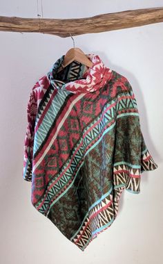 The poncho is the perfect companion for every season: whether with a sweater underneath for autumn and winter or as a cover-up in a cold office. Its bright colors and timeless boho pattern make every outfit an eye-catcher. For me it is an absolute favorite piece that has protected me from the cool breeze while traveling and is the perfect gift for anyone who loves scarves and shawls. It is one size fits all. Its collar is the special highlight: it can be folded over or worn as a stand-up collar. Cheap Multicolor Fall Poncho, Affordable Multicolor Fall Poncho, Cheap Multicolor Winter Poncho, Multicolor Folk Poncho For Winter, Multicolor Folk Style Poncho Shawl, Bohemian One-size Poncho, Cozy Multicolor Alpaca Poncho, Bohemian Poncho For Outdoor, One Size, Boho Poncho