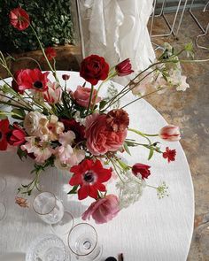 a table with flowers and wine glasses on it