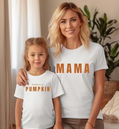 Mama and Mamas Pumpkin Fall Shirts, Mommy and Me Matching, Mom Baby Outfit, Matching Outfits, Kids Fall Shirt, Fall Gifts, Thanksgiving Hi! Welcome. It's great to see you here! ☺️  Our shirts are clean, high quality and soft. It is prepared quickly by our boutique.  Ironing and shipped.  Enjoy your shopping!  It is a pleasure for us to help you with your questions and you can reach us at any time.  Please, don't forget to check our size cards. HOW TO ORDER SHIRT 👕  Please, choose your favorite t-shirt color and size from the pop-up window.  Select the quantity that you want.  Click "ADD TO CART".  You can go back to add more product color for your loved ones members.  You can complete the checkout process.  Please "Click Proceed to Check Out"  Finally, you have completed all the steps, yo Cute White Shirt For Family Events, White Matching Shirt With Name Print, White Family Matching Shirt For Mother's Day, White Tops With Name Print For Family, White Customizable Matching Tops, Mom And Baby Outfits, Outfit Matching, Matching Mom, Pop Up Window