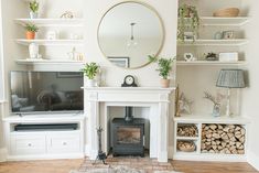 a living room filled with furniture and a fire place in front of a flat screen tv