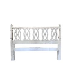 a white wooden headboard with metal rings on the top and bottom posts, against a white background