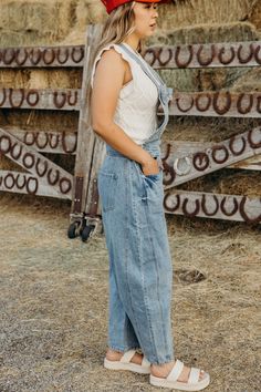 Get ready to rock the denim trend with The Myles Overalls! These barrel jean overalls feature a loose fit and adjustable shoulder straps for ultimate comfort. Perfect for a western-inspired look, these overalls are a must-have for anyone. Courtney is wearing size small paired with The Susana Top and American Cowgirl Trucker Spring Medium Wash Overalls With Adjustable Straps, Spring Jeans With Adjustable Straps, Spring Dark Wash Overalls With Adjustable Straps, Denim Jeans With Pockets For Ranch, Medium Wash Denim Overalls With Suspenders, Spring Overalls Jeans With Suspenders, Medium Wash Denim Jumpsuit With Suspenders And Bib Front, Spring Dark Wash Overalls With Suspenders, Medium Wash Denim Bottoms With Suspenders