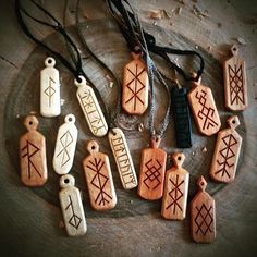 seven wooden pendants with different designs on them