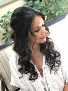 a woman with long hair sitting on a chair