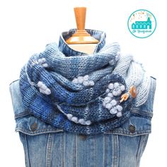 a blue jean jacket with buttons on it and a scarf hanging off the back of it