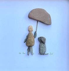 two small rocks and one is holding an umbrella