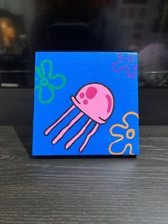 a painting of a pink jellyfish on a blue background