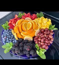 a blue plate topped with fruits and vegetables on top of a stovetop oven burner