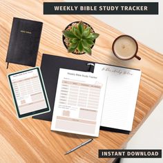 a wooden table topped with notebooks and papers next to a cup of coffee on top of it