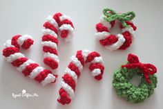 three crocheted candy canes are sitting next to each other