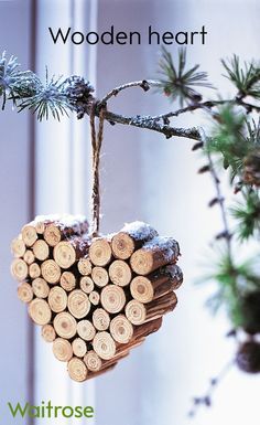 a heart shaped ornament hanging from a tree branch