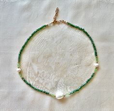 "Dainty ivy-green pearl necklace.                                     🌿✨                                                                                   Mixture of metal, glass and pearl beads.                    Light green beads are Swarovski. Dark green beads are sparkly cubes. Necklace measures 16\" plus extender chain.            Metal is gold colored brass and steel.                       🌿✨                                                                                  To prevent dis Green Faceted Beads Pearl Necklace For Gift, Green Beaded Pearl Necklace For Jewelry Making, Green Pearl Necklace With Beaded Chain For Gifts, Adjustable Green Pearl Necklace, Green Pearl Necklace With Faceted Round Beads, Green Pearl Jewelry With Tiny Beads, Ivy Necklace, Necklace With Pearls, Green Beaded Necklace