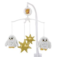 an owl and star mobile is hanging from a white pole with two gold stars on it