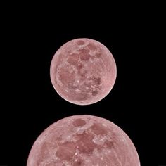 two pink moon's in the dark sky with no one around them or on it