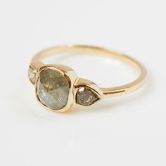 a gold ring with three stones on it