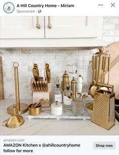 the kitchen counter is covered with gold utensils and other items that are on display