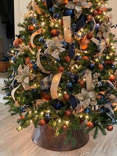 a decorated christmas tree with blue and gold ornaments