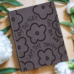 a book with the words i am the way on it surrounded by flowers and leaves