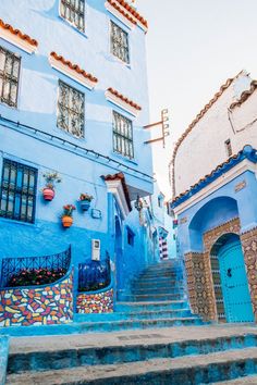 the stairs lead up to some blue buildings