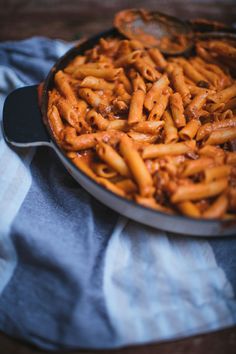 a pan filled with pasta on top of a blue and white towel