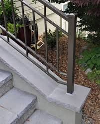 a fire hydrant sitting on the side of a set of stairs next to plants