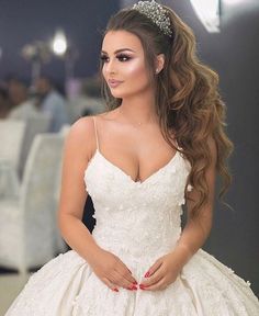 a woman in a wedding dress posing for the camera