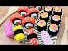 sushi rolls and wooden spoons on a table